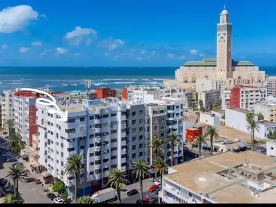 an aerial view of a city with a clock tower at Corniche in Casablanca