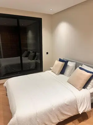 a large white bed in a bedroom with a large mirror at Apartment for rent in the heart of Casablanca in Maarif
