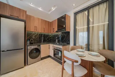 a kitchen with a washer and dryer and a table at New Cosy 1BR Autonome Fibre by- Global Home Stay in Casablanca
