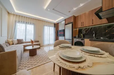 a living room with a table with plates on it at New Cosy 1BR Autonome Fibre by- Global Home Stay in Casablanca