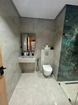 a bathroom with a toilet and a sink and a shower at Apartment Témara Ideal Center High Standing in Temara