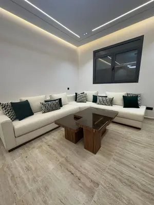 a living room with a couch and a coffee table at Apartment Témara Ideal Center High Standing in Temara