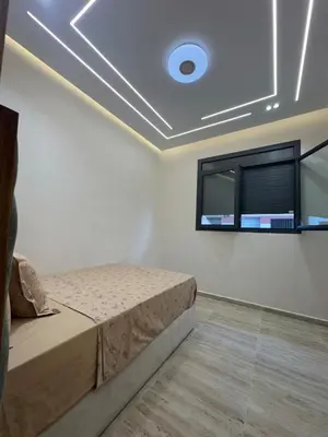 a bedroom with a bed and a window at Apartment Témara Ideal Center High Standing in Temara