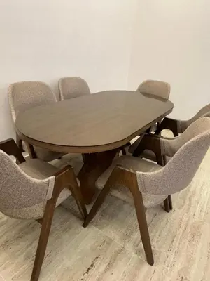 a wooden table with chairs in a room at Apartment Témara Ideal Center High Standing in Temara