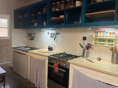 a kitchen with blue cabinets and a stove at Villa Cosy aux Sablettes, plage à deux pas in Mohammedia