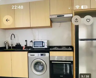 a kitchen with a washing machine and a microwave at CMN airport apartment in Nouaseur