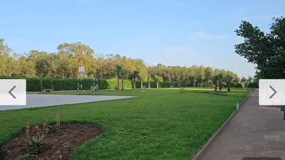 a park with two white signs in the grass at CMN airport apartment in Nouaseur