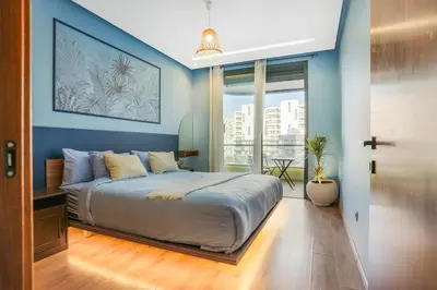 a bedroom with a large bed with blue walls at Premium Stay Near Aeria Mall CFC- Feels like Home in Casablanca