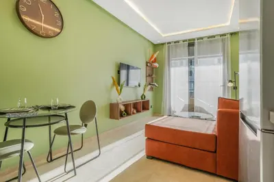 a room with a bed and a table and a clock at Premium Stay Near Aeria Mall CFC- Feels like Home in Casablanca