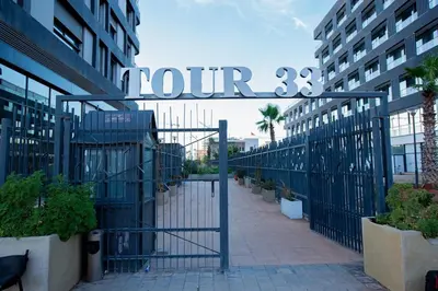 a metal gate with a sign that reads tour at Neon Terrace in 12th Floor CFC Casablanca in Casablanca