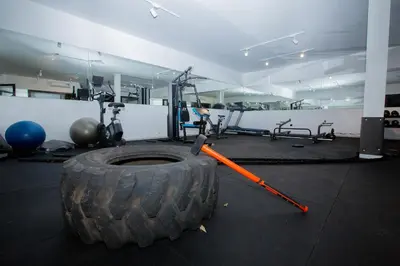 a gym with a large tire and exercise equipment at Neon Terrace in 12th Floor CFC Casablanca in Casablanca