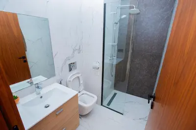 a bathroom with a shower and a toilet and a sink at Neon Terrace in 12th Floor CFC Casablanca in Casablanca