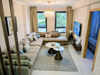 a living room with a couch and a table at Comfort & Elegance, Station and Tram Access in Casablanca