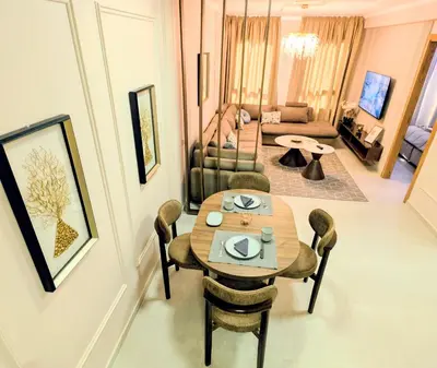 a living room with a table and chairs and a couch at Comfort & Elegance, Station and Tram Access in Casablanca