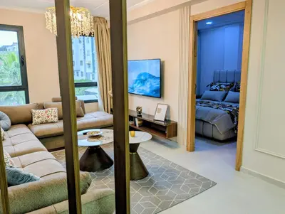 a living room with a couch and a bed at Comfort & Elegance, Station and Tram Access in Casablanca
