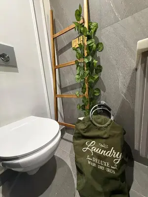 a bathroom with a toilet and a bag with a plant at Cosy and charming studio - parking & Terasse in Maarif