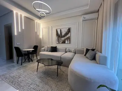 a living room with a couch and a table at Beautiful appartement with pool and ocean view in Aïn Harrouda