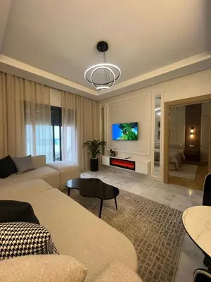 a living room with a couch and a tv at Beautiful appartement with pool and ocean view in Aïn Harrouda