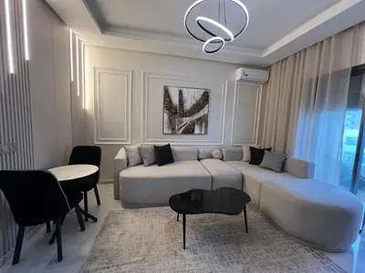 a living room with a couch and a table at Beautiful appartement with pool and ocean view in Aïn Harrouda