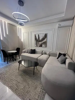 a living room with a couch and a table at Beautiful appartement with pool and ocean view in Aïn Harrouda