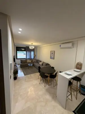 a living room with a couch and a table at Studio for rent couple in Casablanca