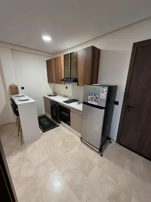 a kitchen with a refrigerator and a stove top oven at Studio for rent couple in Casablanca