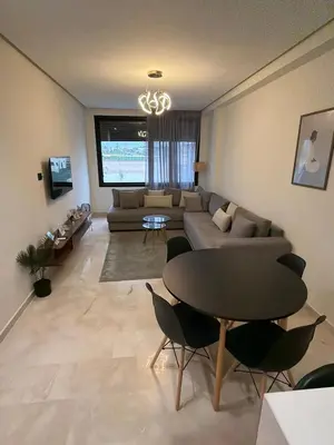 a living room with a couch and a table at Studio for rent couple in Casablanca