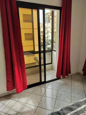 a room with red curtains and a glass window at Val Fleurie in Casablanca