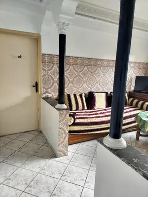 a living room with a couch and a stove at Val Fleurie in Casablanca