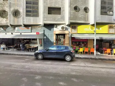 a blue car parked on the side of a city street at Val Fleurie in Casablanca