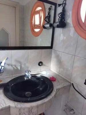 a bathroom with a black sink and a mirror at Val Fleurie in Casablanca