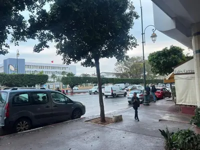 a young child walking down a sidewalk next to a tree at Perle de rabat 2 in Rabat