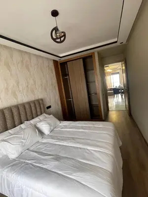 a bedroom with a white bed with a ceiling at Studio cosy au coeur de casa - propre et sécurisé in Casablanca