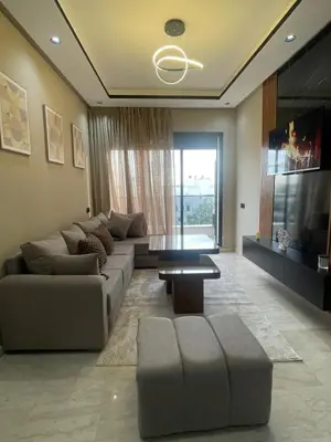 a living room with a couch and a table at Studio cosy au coeur de casa - propre et sécurisé in Casablanca