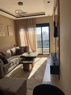 a living room with a couch and a table at Studio cosy au coeur de casa - propre et sécurisé in Casablanca