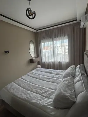 a white bed in a bedroom with a window at Studio cosy au coeur de casa - propre et sécurisé in Casablanca