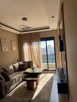 a living room with a couch and a table at Studio cosy au coeur de casa - propre et sécurisé in Casablanca