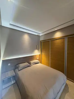 a bedroom with a large bed with a wooden wall at Nice studio for rent in Casablanca