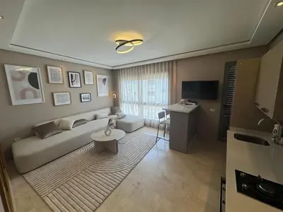 a living room with a couch and a table at Nice studio for rent in Casablanca