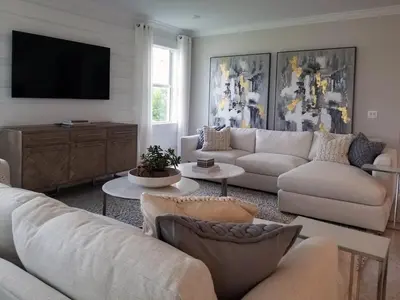 a living room with white furniture and a flat screen tv at Vbilla 5 stars in Tamaris