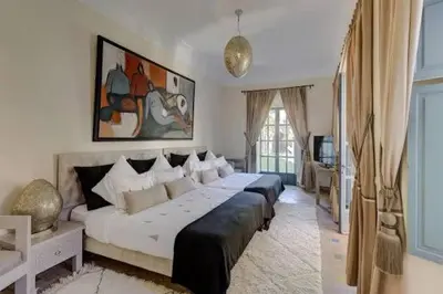 a large bedroom with two beds in it at Vbilla 5 stars in Tamaris
