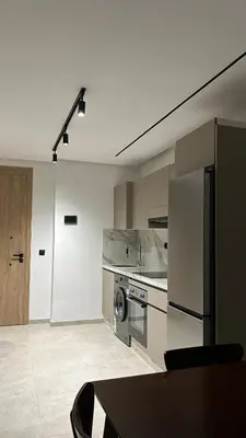 a kitchen with a refrigerator and a stove top oven at Central Casablanca Cozy Home in Casablanca