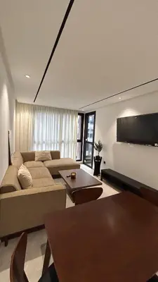 a living room with a couch and a flat screen tv at Central Casablanca Cozy Home in Casablanca