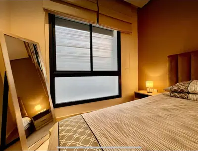 a bedroom with a bed and a large window at Anfa City in Casablanca