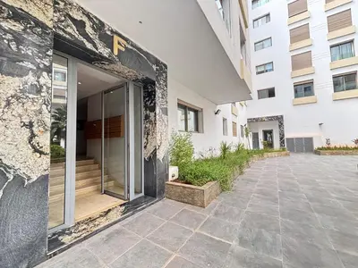 a building with a glass door in a courtyard at Seabreeze home on the Corniche in Casablanca