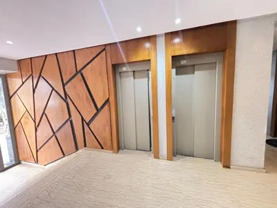 a row of elevators in a building with wood at Seabreeze home on the Corniche in Casablanca