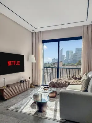 a living room with a tv and a couch at Chic Studio I Anfa Park & CFC I Gym Wifi & Parking in Casablanca
