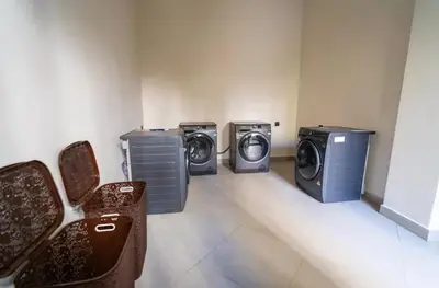 three washing machines and a washer and dryer in a room at Chic Studio I Anfa Park & CFC I Gym Wifi & Parking in Casablanca