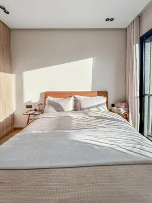 a bedroom with a large bed with a large window at Chic Studio I Anfa Park & CFC I Gym Wifi & Parking in Casablanca