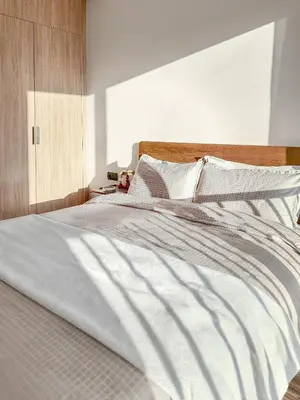 a large white bed with white sheets and pillows at Chic Studio I Anfa Park & CFC I Gym Wifi & Parking in Casablanca